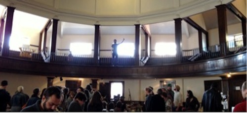 Chris Fritton, balcony, directs the Buffalo Small Press Book Fair.