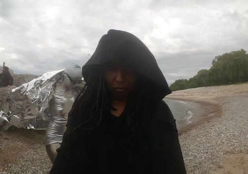 Foreground Duriel E. Harris as Jack/Death, background Lisa Samuels as EULA (End User Licensing Agreement). (photograph provided by author)] 