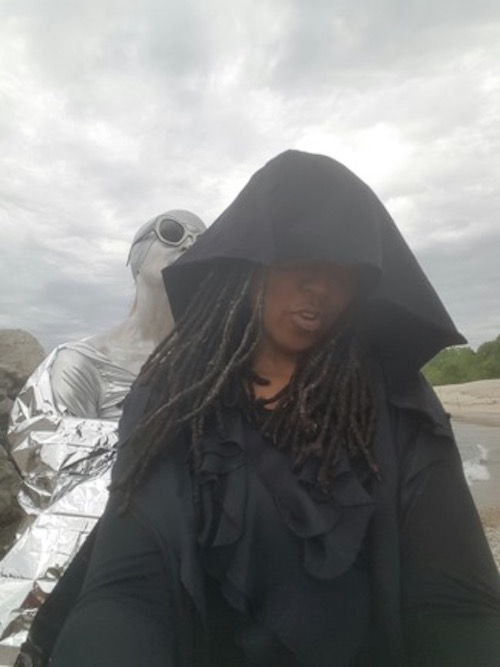 Foreground Duriel E. Harris as Jack/Death, background Lisa Samuels as EULA (End User Licensing Agreement). (photograph provided by author)] 