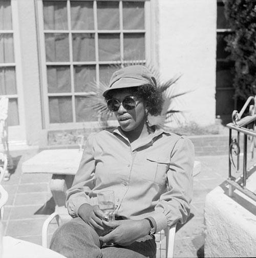 Poet Rita Dove wears sunglasses and holds a cup outside the University of Arizona Poetry Center in Tucson, Arizona.