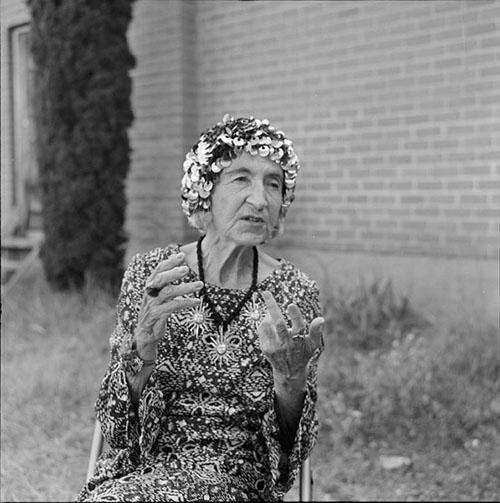 Poet Helen Adam talking with her hands and wearing a sequined hat at the 1981 Bisbee Poetry Festival in Bisbee, Arizona. 