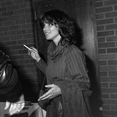 Poet, editor, and translator Carolyn Forché with a cigarette in one hand in the University of Arizona Modern Languages Building after her reading for the Poetry Center's Fall 1983 Reading and Lecture Series. 