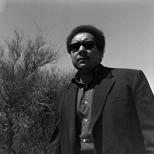 Poet Michael S. Harper poses in sunglasses for the University of Arizona Poetry Center's Spring 1973 Reading and Lecture Series. 