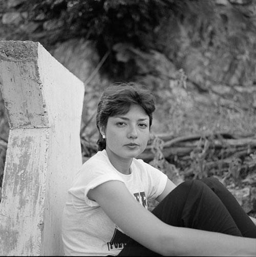 Poet and editor Joyce Jenkins sits holding her knees at the 1981 Bisbee Poetry Festival in Bisbee, Arizona. 