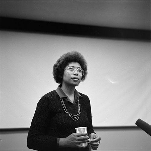 Novelist, short story writer, and poet Alice Walker stands in front of a classroom at Southwest Texas State University in San Marcos, Texas. 1981. 