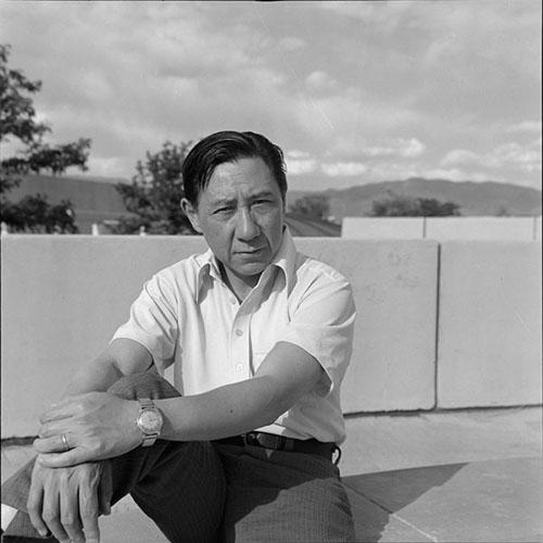 David Raphael Wang sits with arms resting on one raised knee. 1975.